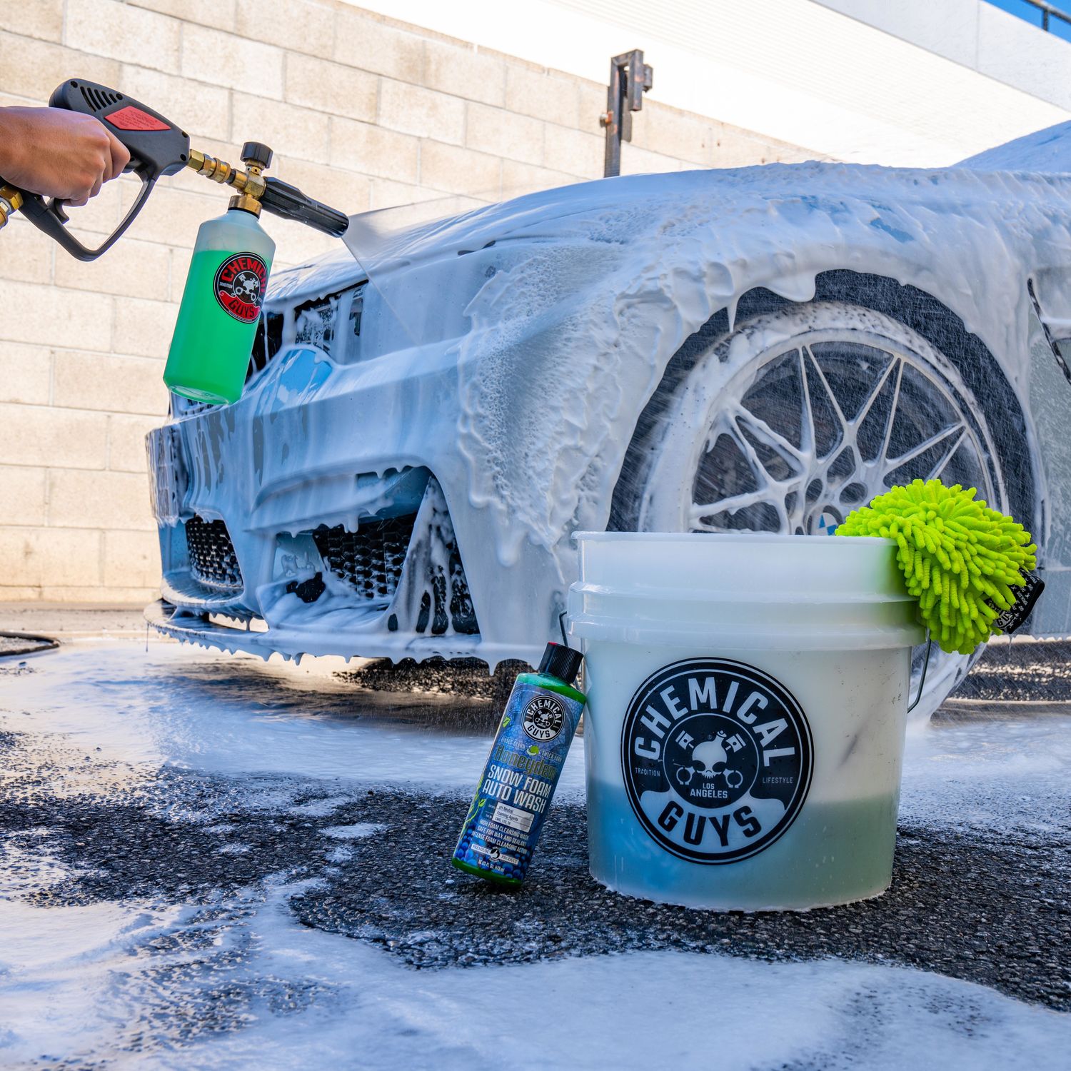 Cleaning car using active foam. Man washing his car on self car